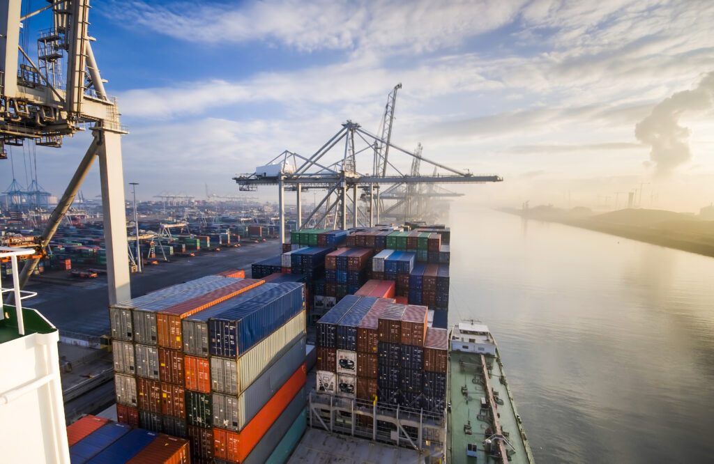 Grosses beladenes Containerschiff laeuft aus dem Hafen